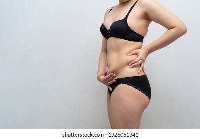 Young Asian Woman In Bra And Love Handles With Belly Fat. Health Care, Beauty And Female Concept