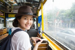 Young Asian Woman In The Bus With Rainy Day.