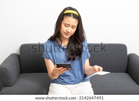Young asian woman calculating household expenses and finance, feel frustrated at home, girl worried about debt and tax.