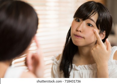 Young Asian Woman Checking Her Skin.