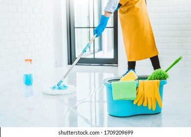 Young asian woman cleaning house Sweeping the floor with a mop House keeping concept - Shutterstock ID 1709209699