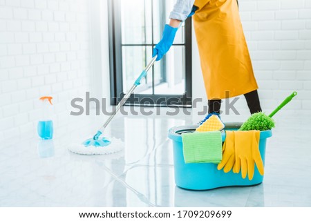 Young asian woman cleaning house Sweeping the floor with a mop House keeping concept