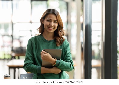 Young Asian Woman, Company Worker, Smiling And Holding Digital Tablet, Standing In Her Office.