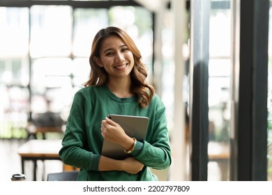 Young Asian Woman, Company Worker, Smiling And Holding Digital Tablet, Standing In Her Office.