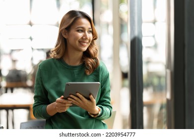 Young Asian Woman, Company Worker, Smiling And Holding Digital Tablet, Standing In Her Office.