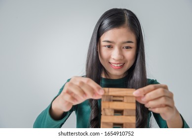 Young Asian Woman Constuction Wood Block, Grow Up Business Solutions Success Process.