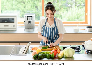 Young Asian Woman Cooking In The Kitchen.