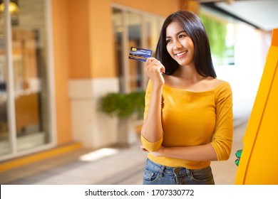 Young Asian Woman With Credit Card On The Street