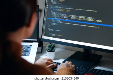 Young Asian woman, developer programmer, software engineer, IT support, wearing glasses working hard at night overtime on computer to check coding in bugging system. Back view - Shutterstock ID 2152034549