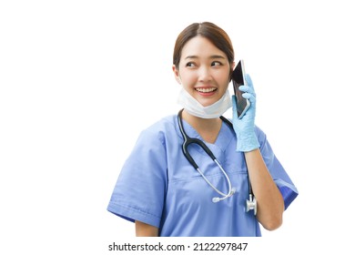 Young Asian Woman Doctor Nurse Wearing A Surgical Mask On Her Chin Looking Sideways To Copyspace Giving Consult And Instruction And Diagnose The Patient Health Problem Though Healthcare Phone Service.