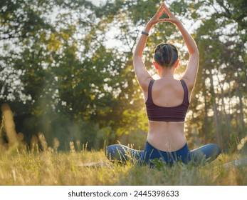 Young asian woman doing meditation in morning or evening at park, healthy woman relaxing and practicing yoga at city park. Mindfulness, destress, Healthy habits and balance concept - Powered by Shutterstock