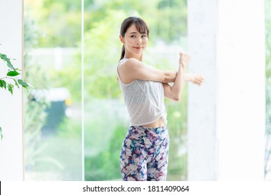 Young asian woman doing stretch. Health care. Body care.