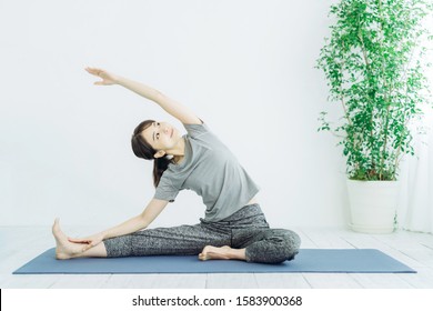 Young Asian Woman Doing Yoga.