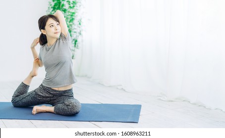 Young Asian Woman Doing Yoga. Pose Of Pigeon.