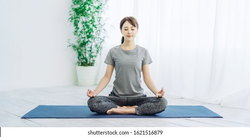 Young asian woman doing yoga. - Shutterstock ID 1621516879