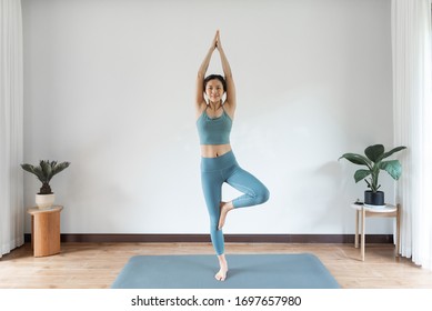 A Young Asian Woman Doing Yoga At Home