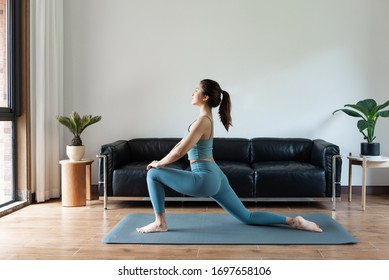 A Young Asian Woman Doing Yoga At Home