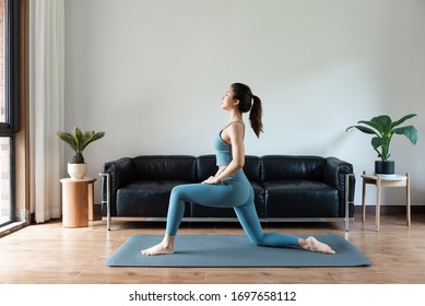 A Young Asian Woman Doing Yoga At Home