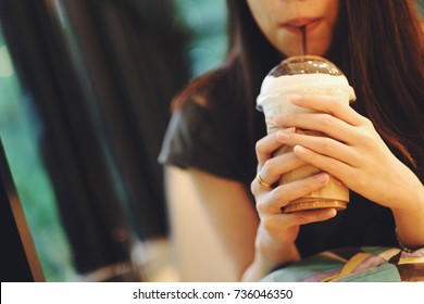 Young Asian Woman Drinking Ice Coffee In Cafe Shop.