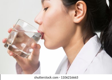 Young Asian woman drinking water - Shutterstock ID 1106216663