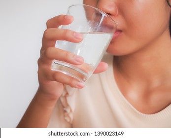 Young asian woman drinking water.