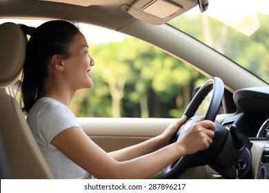 Young Asian Woman Driver Driving A Car 