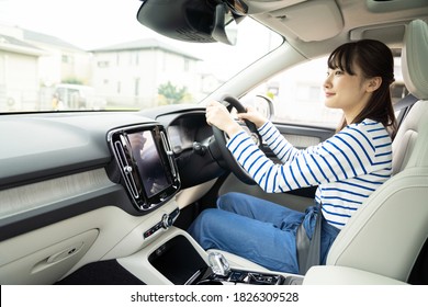 Young Asian Woman Driving A Car.