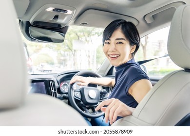 Young Asian Woman Driving A Car.