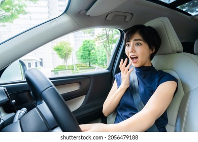 Young Asian Woman Driving A Car. Traffic Accident.