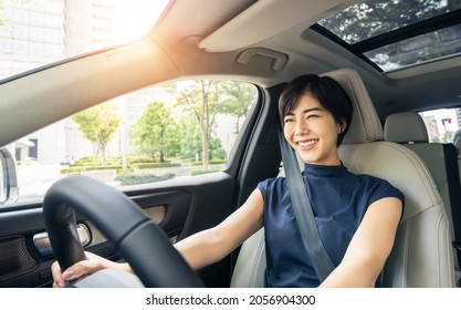 Young asian woman driving a car. - Shutterstock ID 2056904300