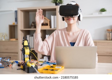 Young Asian Woman Engineer Programer Wear Vr Control Learning Robot Arm Ai Coding Programer Working On Robotics Project  At Home