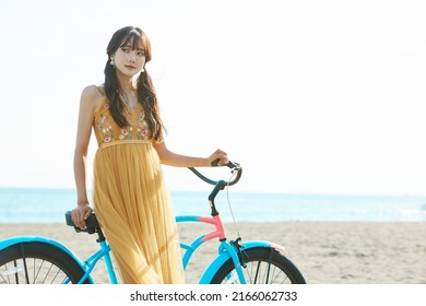 Young Asian Woman Enjoying The Resort On The Beach