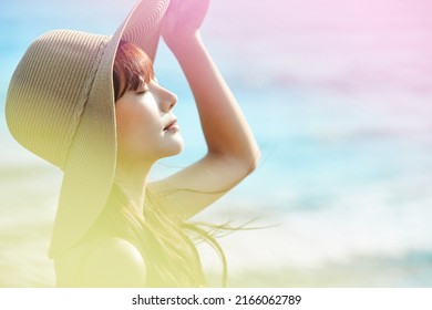 Young Asian woman enjoying the resort on the beach