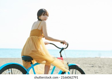 Young Asian Woman Enjoying The Resort On The Beach