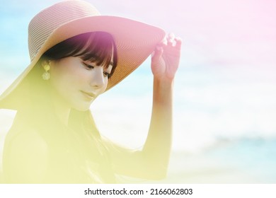 Young Asian Woman Enjoying The Resort On The Beach