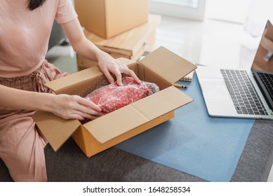 Young Asian Woman Entrepreneur Working Packing The Order For Shipping To Customer At House.