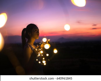 Young Asian Woman With Fairy Lights In Sweet Sunset.