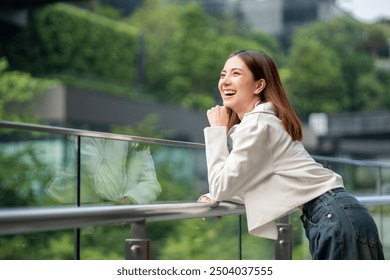 Young asian woman fashion lifestyle with headphone standing posing in urban city downtown. Happy attractive charming asian female living in city. People and lifestyle. - Powered by Shutterstock