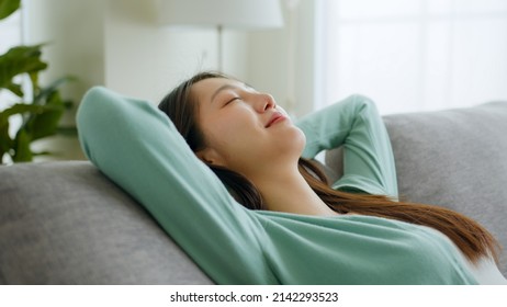 Young Asian Woman Feeling Relax On Sofa At Home On Weekend Holiday.