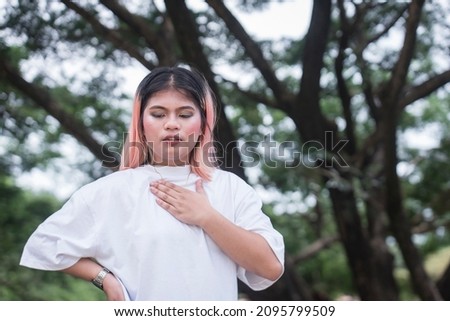 A young asian woman feels rapid, fluttering heartbeat on her chest. Possible cardiac problems, dyspnea or anxiety attack.