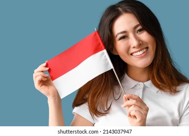 Young Asian Woman With Flag Of Indonesia On Blue Background