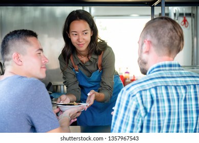 Young Asian Woman Food Truck Business Owner Serving Food To A Customer