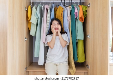 Young Asian Woman With Full Wardrobe
