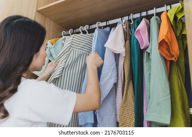 Young Asian Woman With Full Wardrobe
