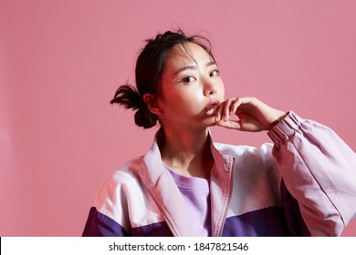 Young Asian Woman With Glitter Make-up Wearing Sporty Fashion