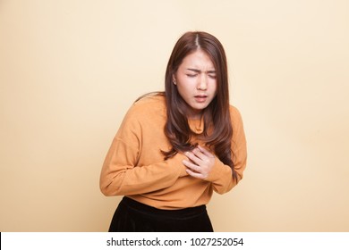 Young Asian Woman Got Chest Pain On Beige Background