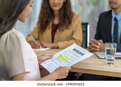 Young Asian woman graduate holding the resume document and preparing to two manager before start to job interview with positive motion in meeting room,Business Hiring new member concept