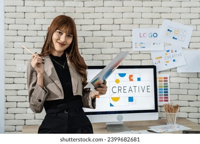 Young asian woman graphic designer working in office. Artist Creative Designer Illustrator Graphic Concept, corporate women in creative marketing team working on project management, looking camera - Powered by Shutterstock