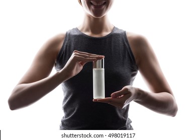 Young Asian woman with hands showing serum bottle. Product advertisement isolated on white background.