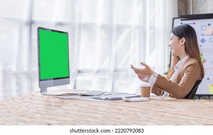 Young Asian Woman Having Zoom Video Conferencing Call Via Computer. Home Office. Stay At Home And Work From Home Concept 